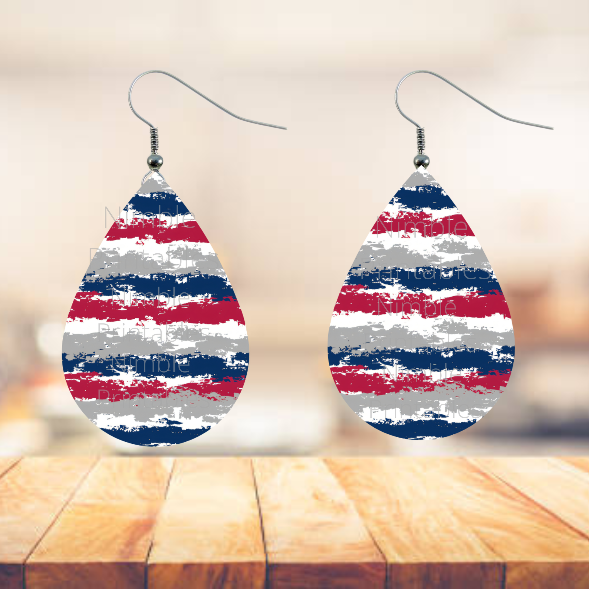 Tear-drop earrings with red, white, and blue distressed stripe pattern.
