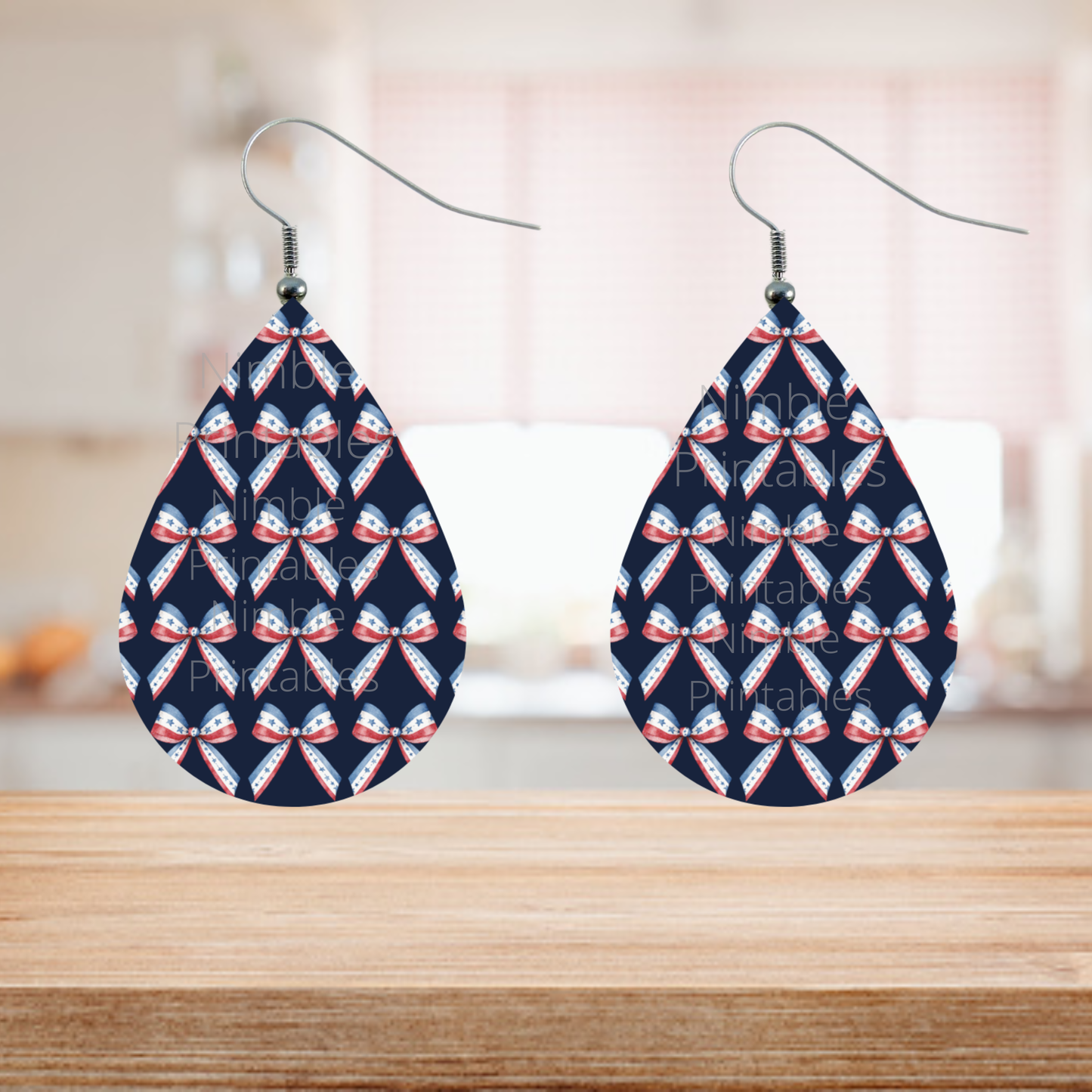 Teardrop earrings with repeating red, white, and blue bow pattern.