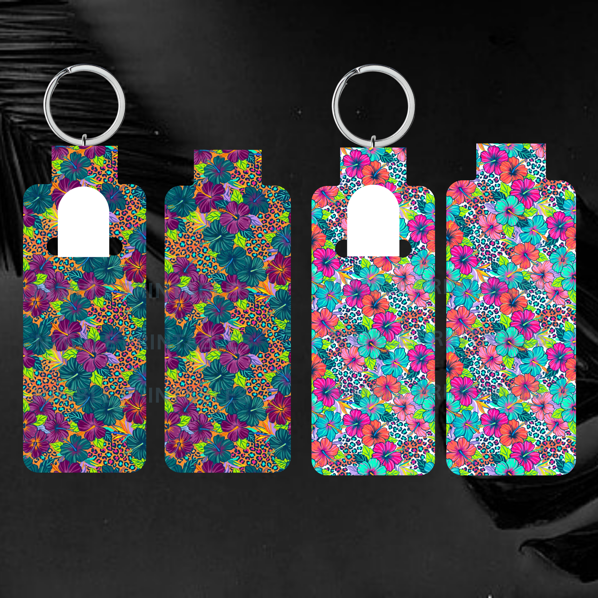 Four patterned hand sanitizer holders with keychains on black background.