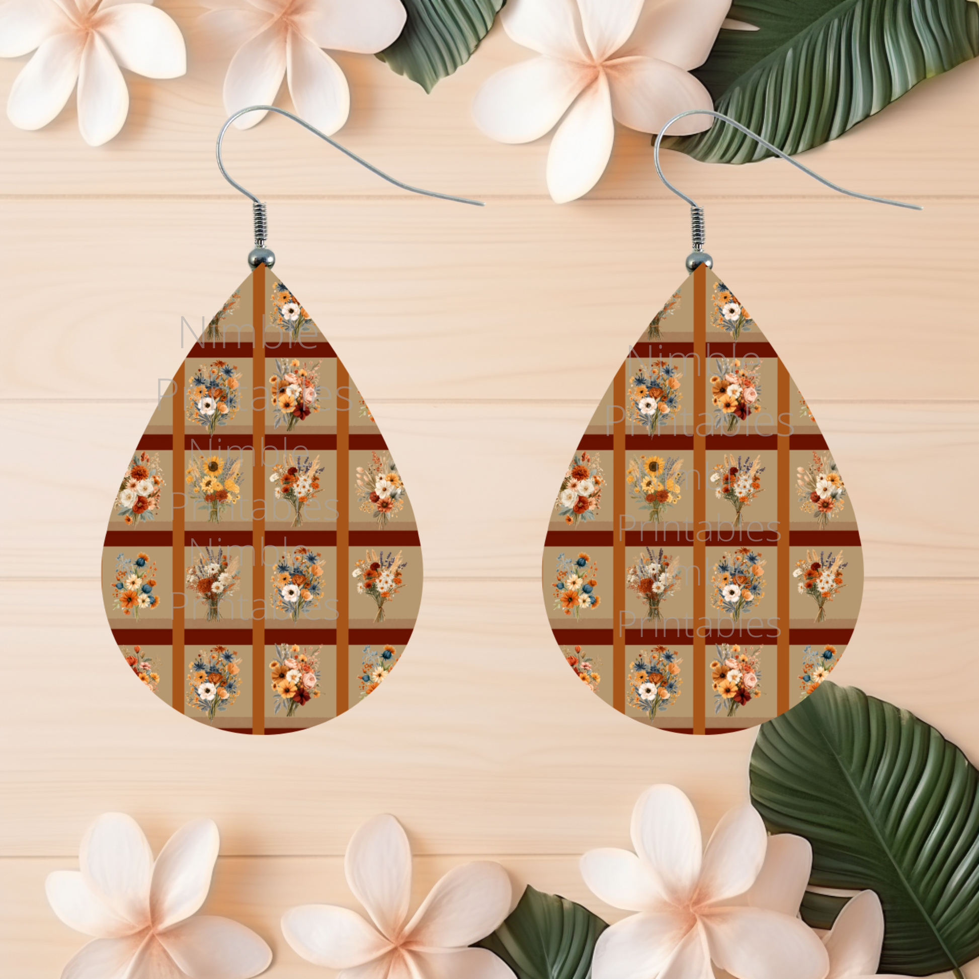 Teardrop earrings with a plaid pattern of fall floral bouquets on a beige background.