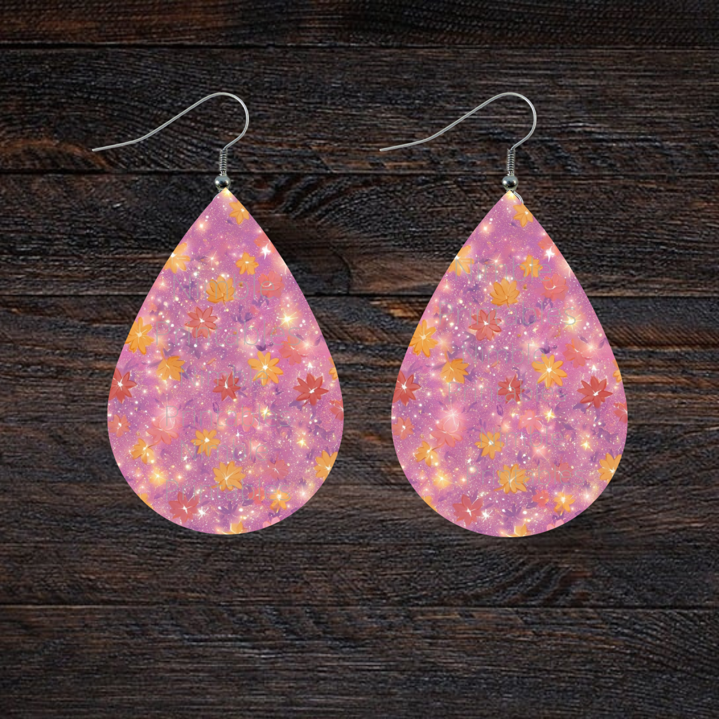 Teardrop earrings with pink background and scattered floral pattern.