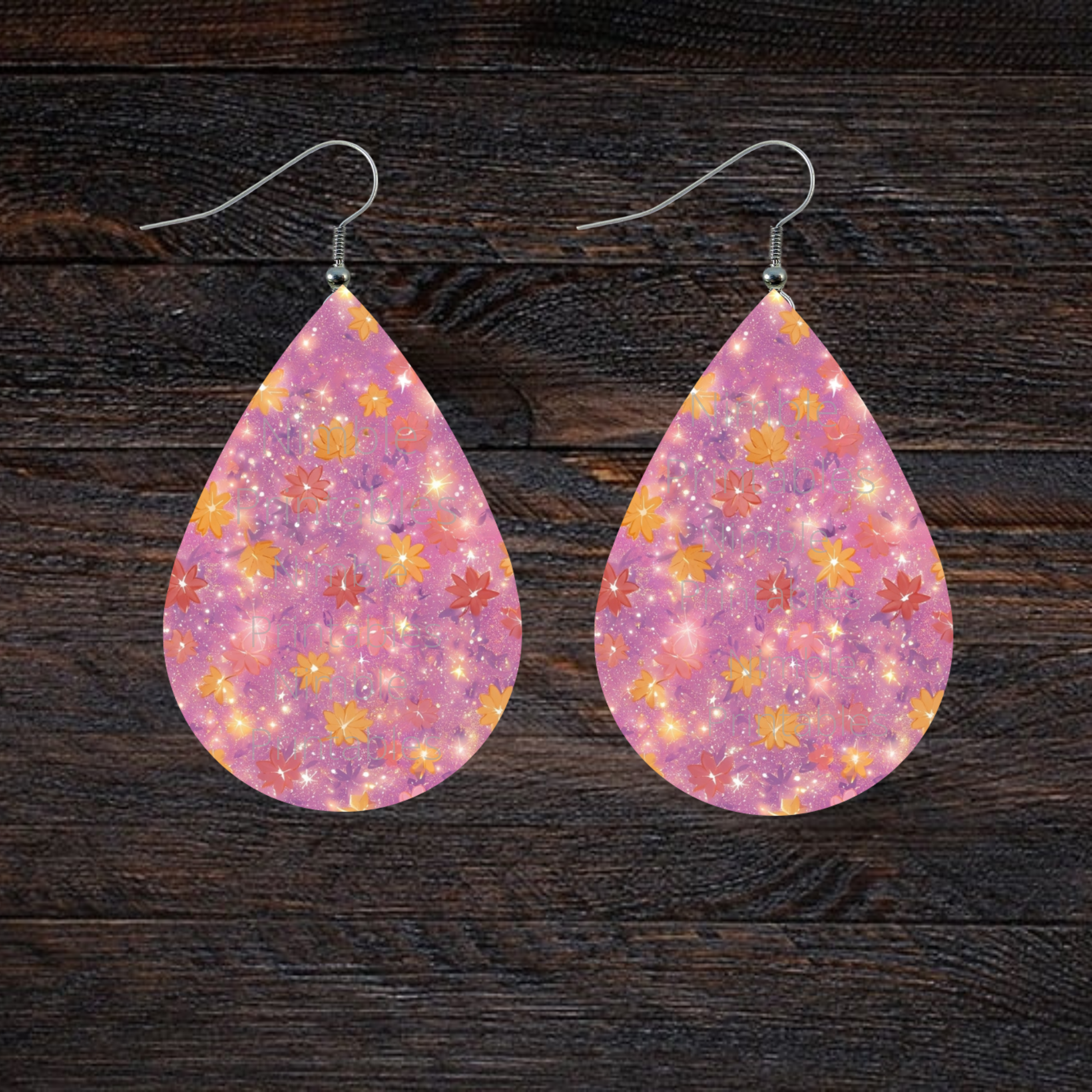 Teardrop earrings with pink background and scattered floral pattern.
