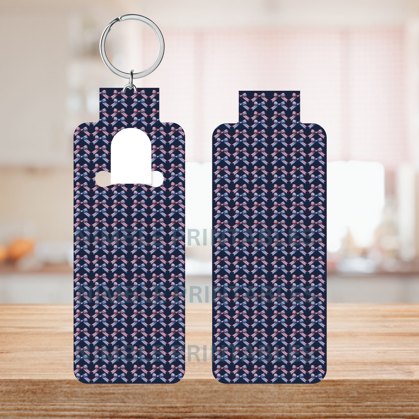 Two identical keychains with a dark blue patterned design on a wooden surface.