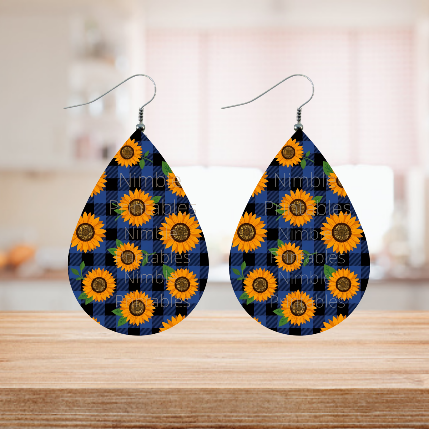 Teardrop earrings with sunflowers on blue buffalo plaid pattern.