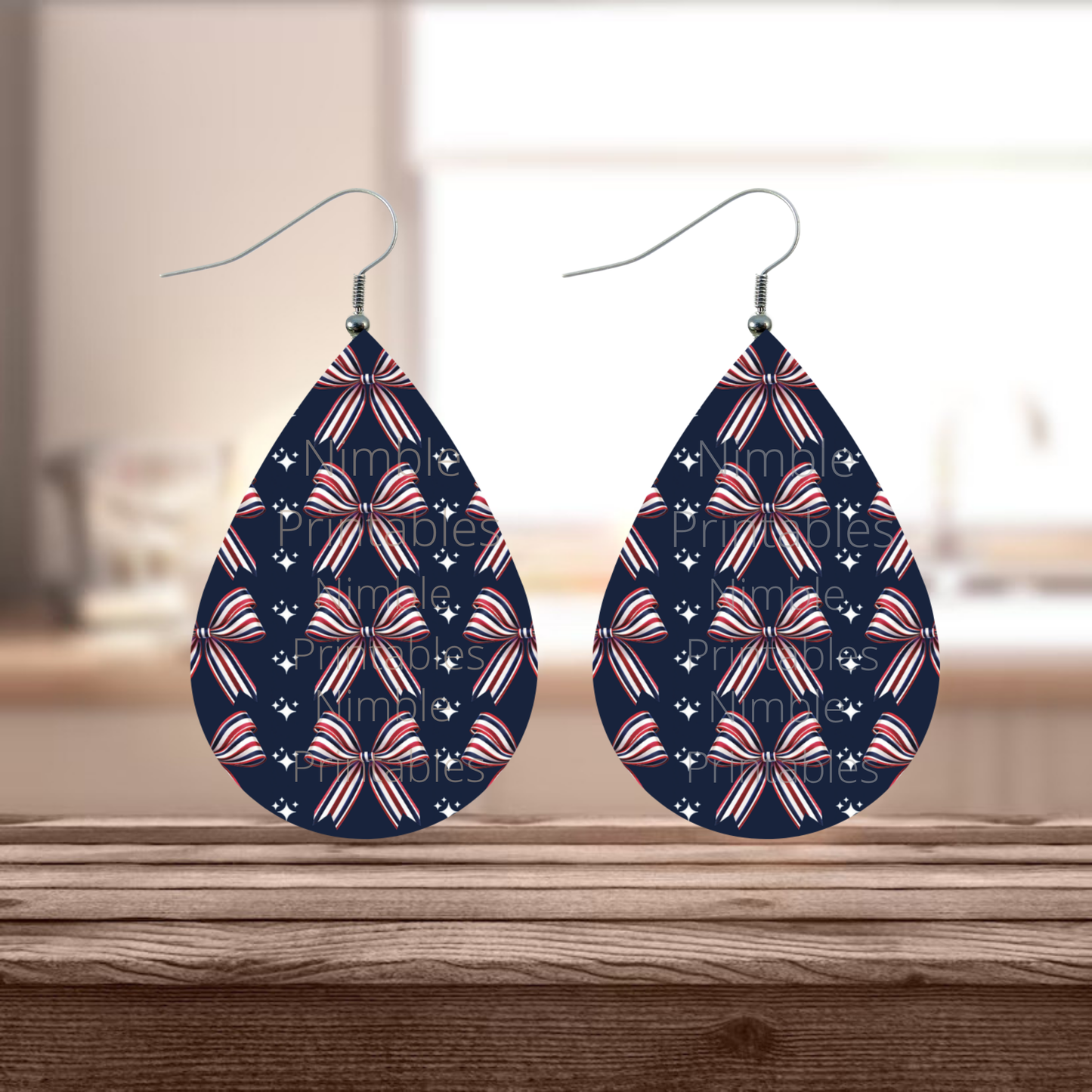 Teardrop earrings with red, white, and blue striped bow pattern.