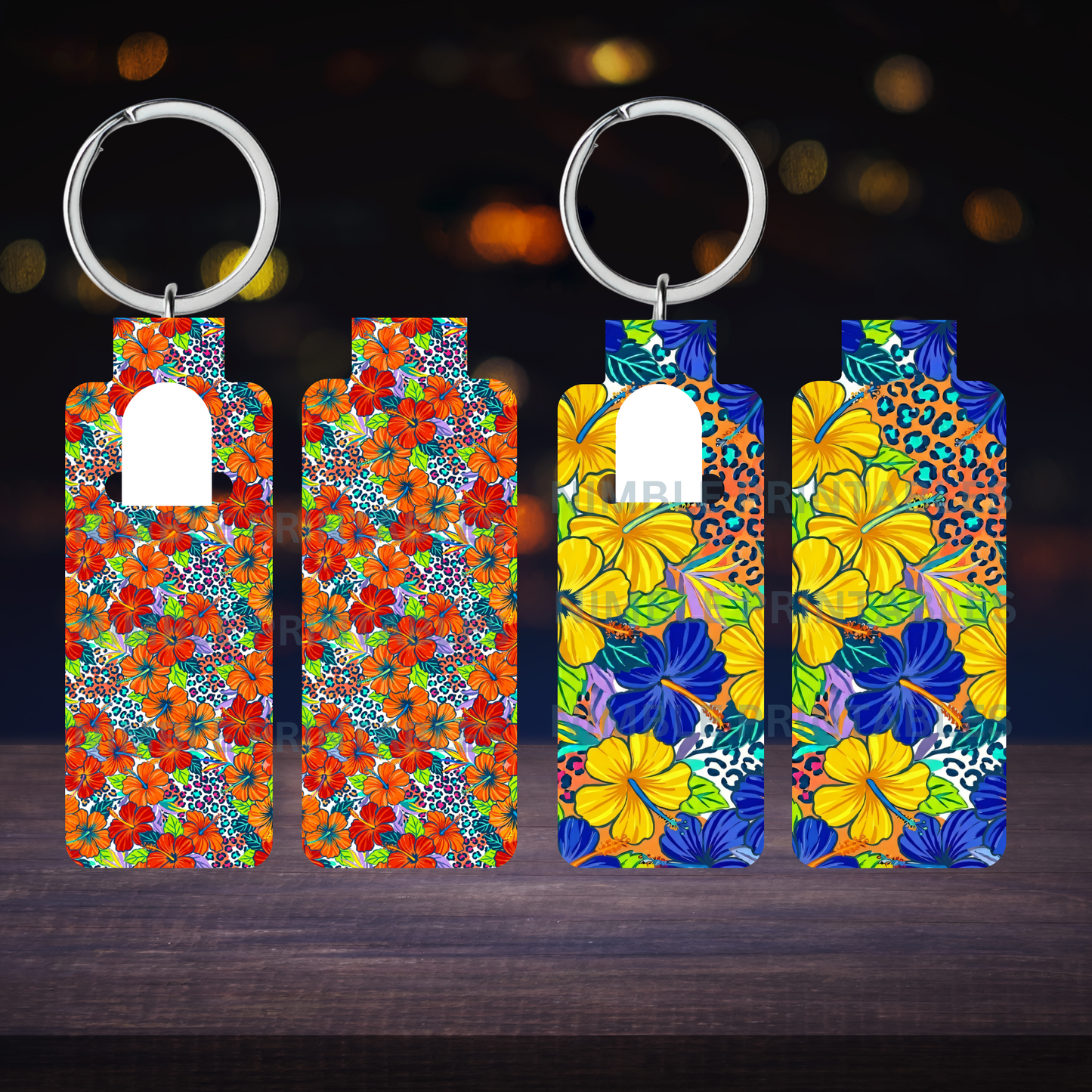 Four floral pattern hand sanitizer holder keychains displayed on a dark wooden surface.