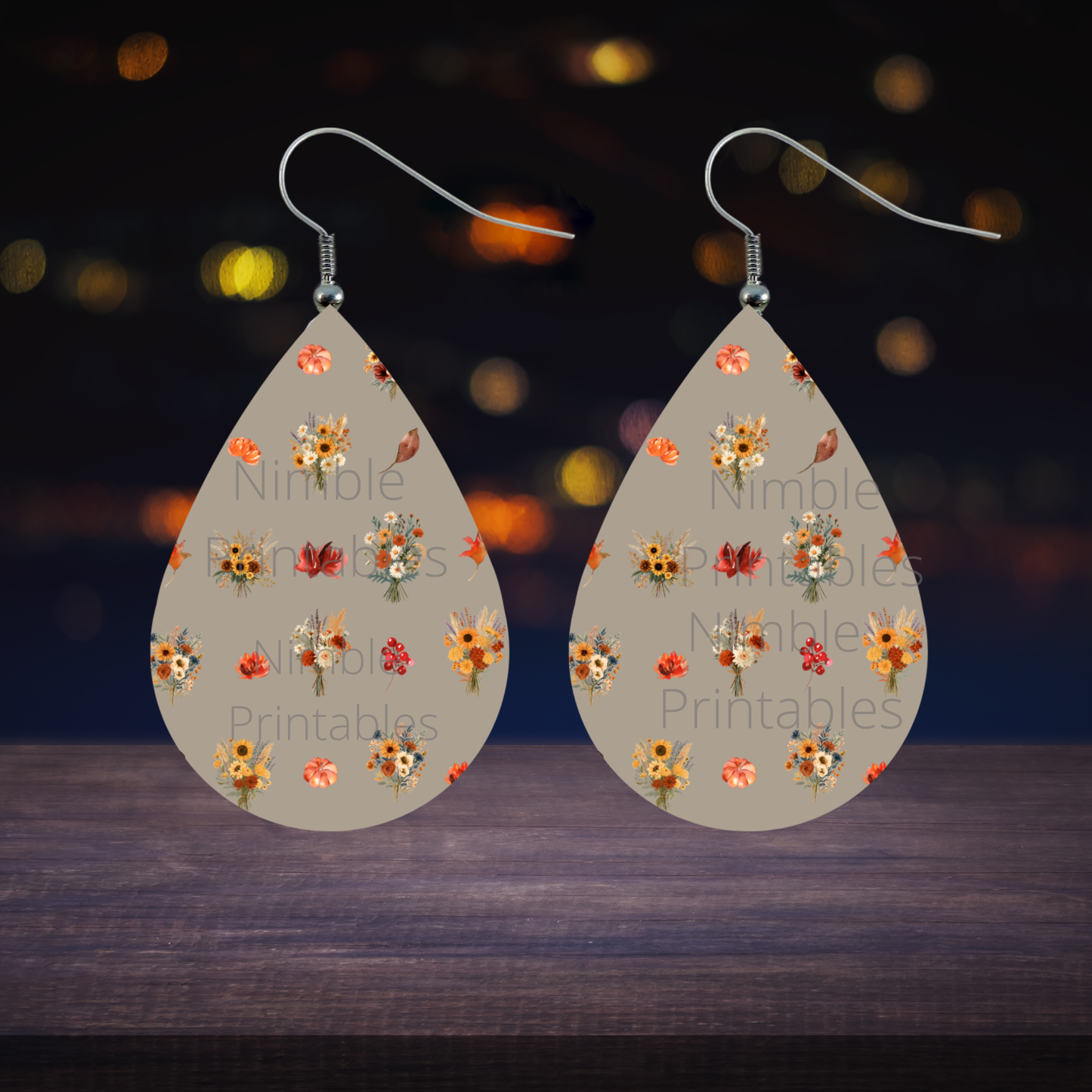 Teardrop earrings with fall floral and pumpkin pattern on taupe background.