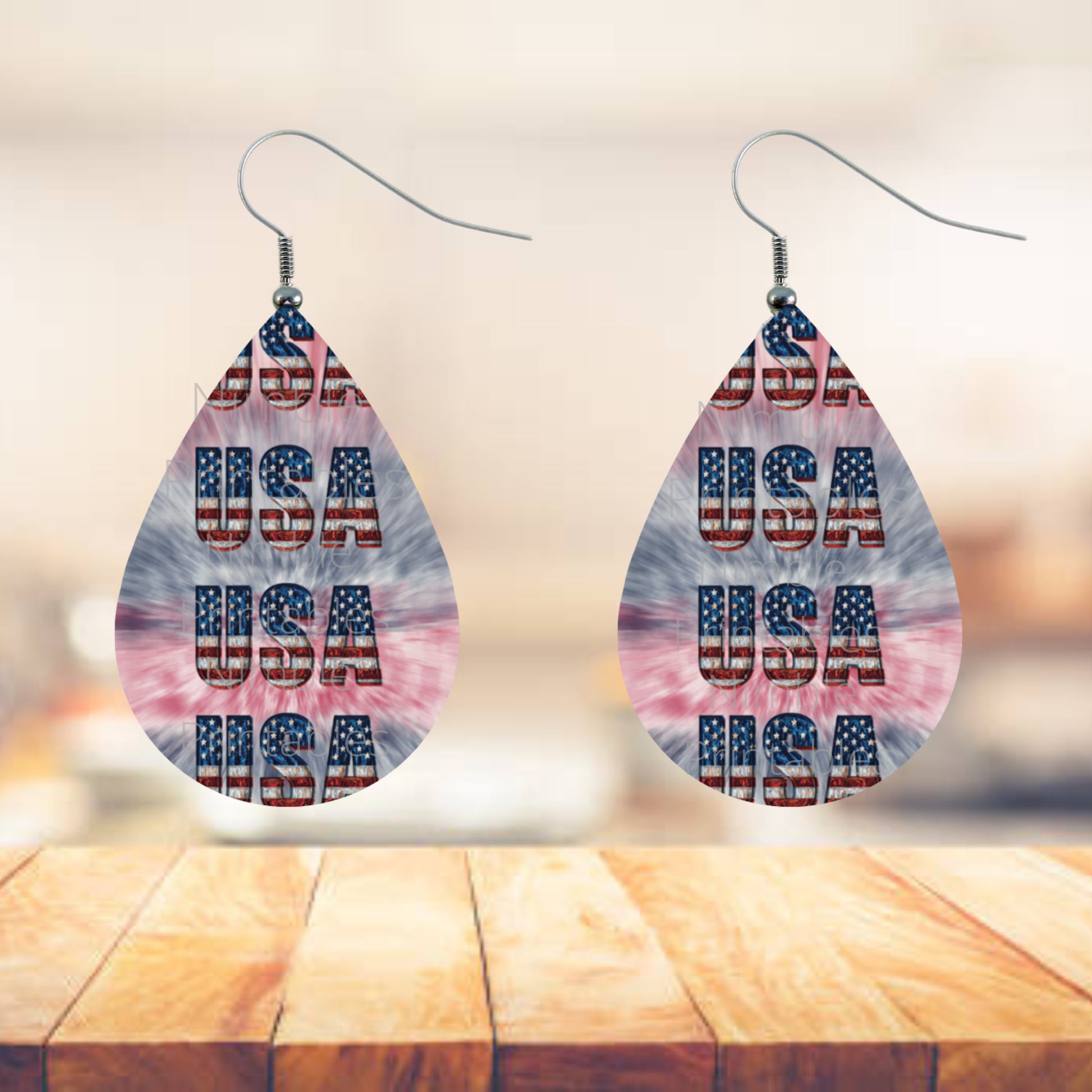 Teardrop earrings with "USA" text in American flag pattern.
