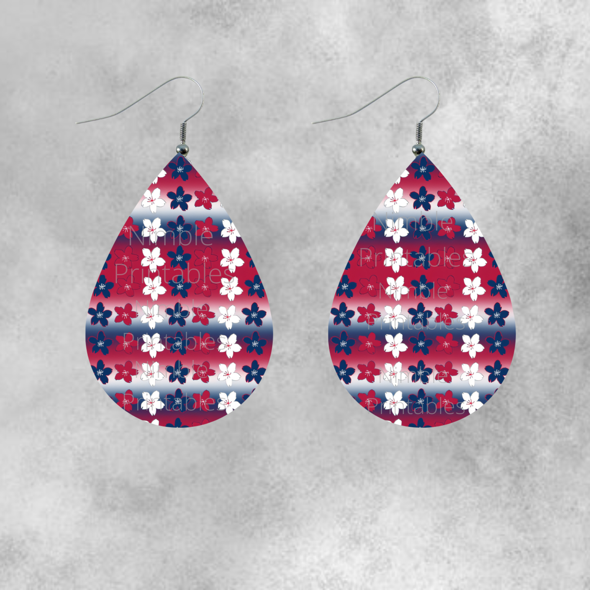 Teardrop earrings with red, white, and blue floral pattern on striped background.